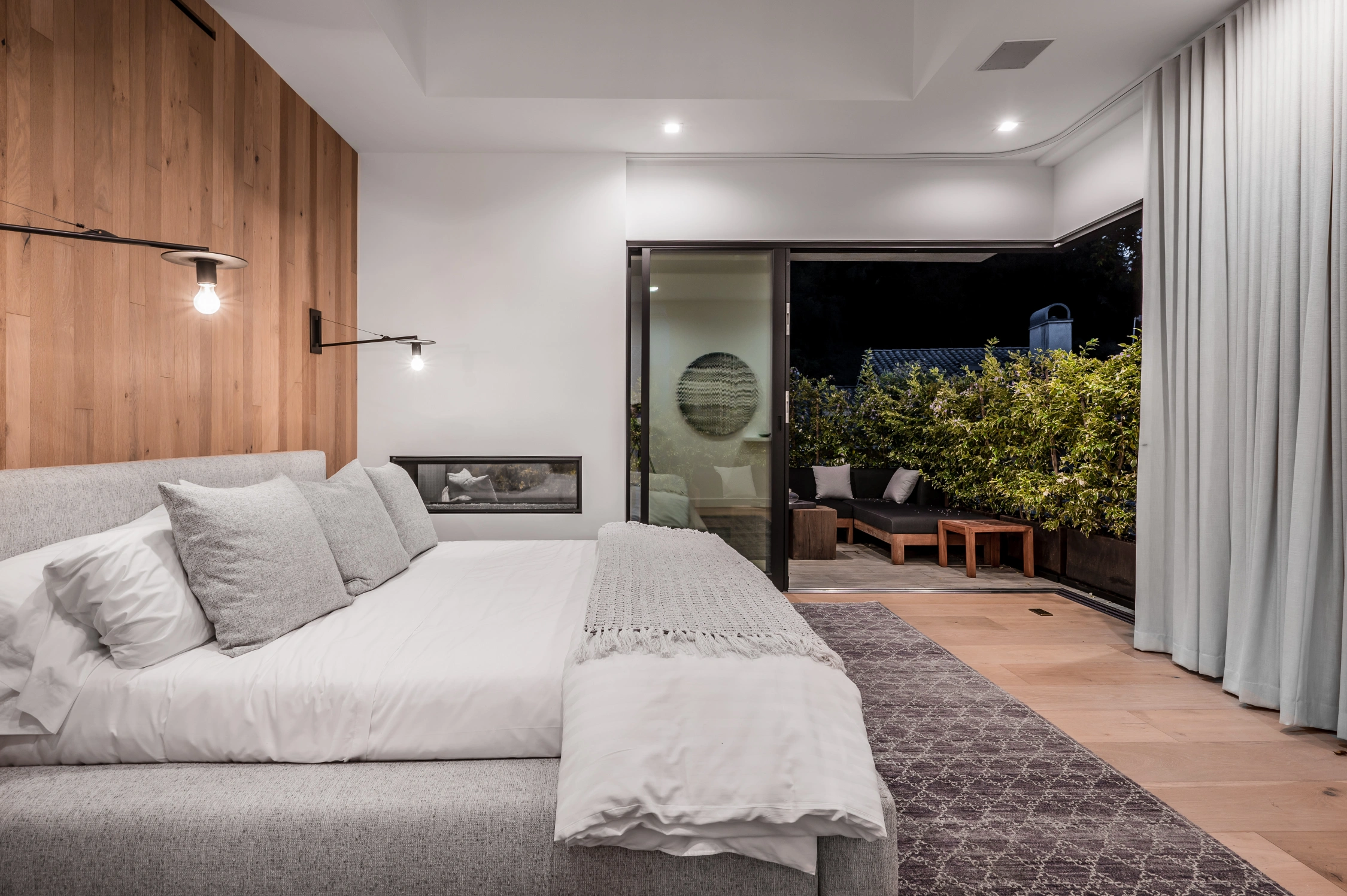 a-bedroom-with-a-wooden-paneled-wall-and-a-large-b-2026-03-18-16-08-02-utc